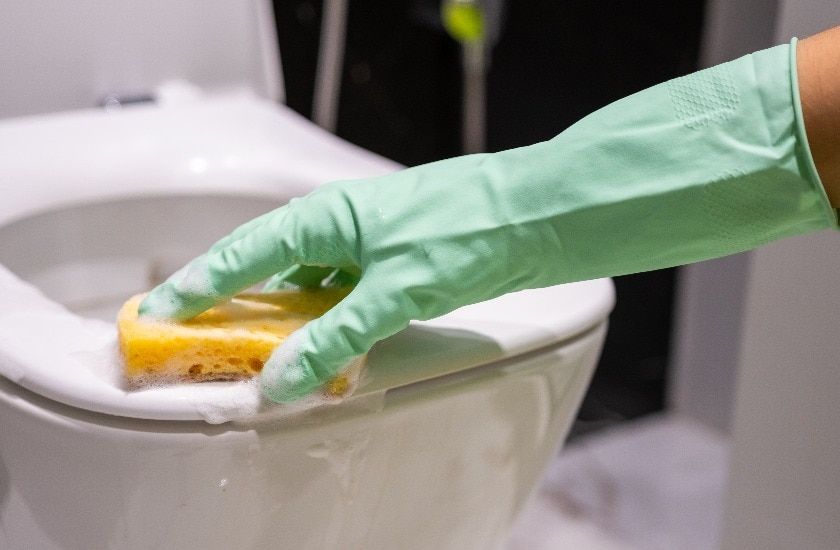 Cleaning the toilet bowl from dirt and infection with sponge detergent