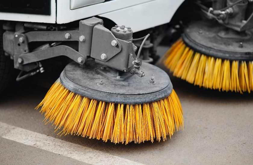 Close-up street sweeper machine cleaning the streets. Concept clean streets from debris.